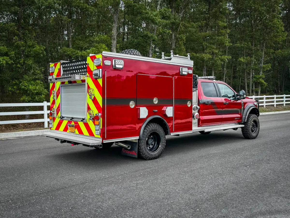 Rear-right three-quarter exterior view showing rear corner lighting and hosebed net.